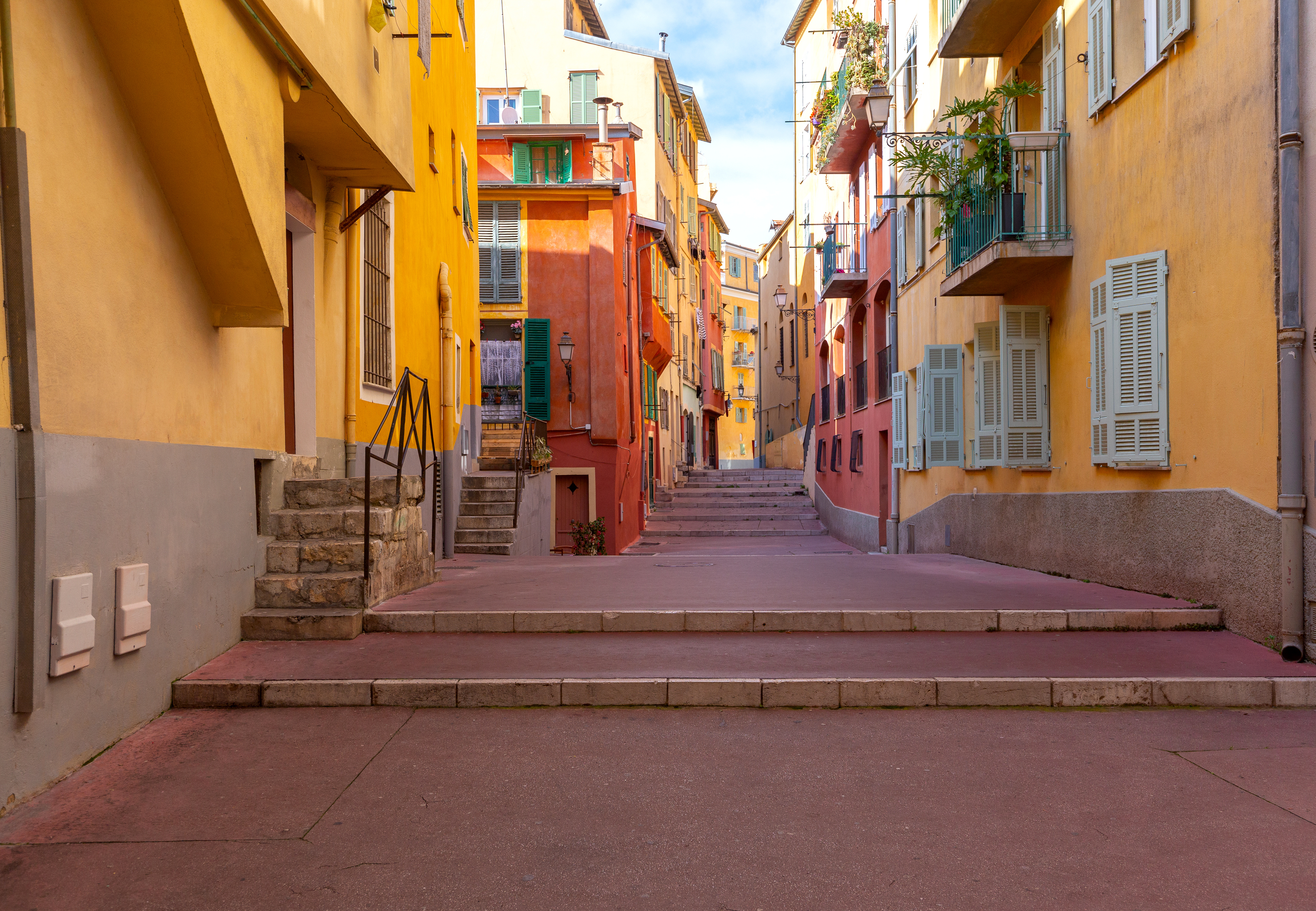 Multicolored facades of houses and narrow medieval streets. Nice. France.