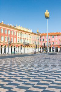 NICE, FRANCE - AUGUST 21: Tourists walking in the Place Massena, on August 21, 2015 in Nice, France. The place is the most famous of the city because of its beauty, shopping options and the carnival.